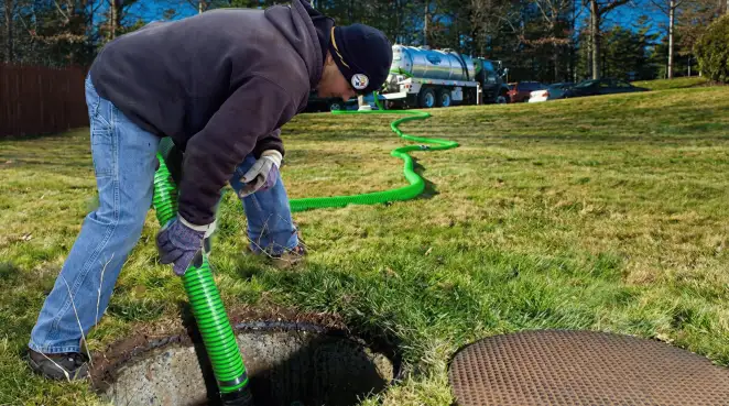 Service technician performing residential septic pumping and drainage maintenance in Tucson, AZ